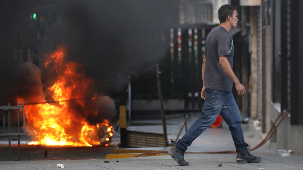 
Clashes broke out between anti-Maduro protesters and police [Carlos Garcia Rawlins/Reuters]
