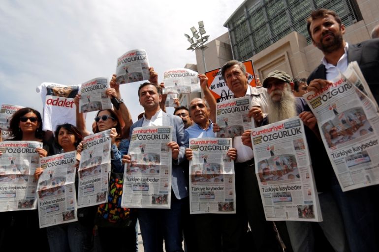 Press freedom activists hold copies of the opposition newspaper Cumhuriyet during a demonstration in solidarity with the jailed members of the newspaper outside a courthouse, in Istanbul