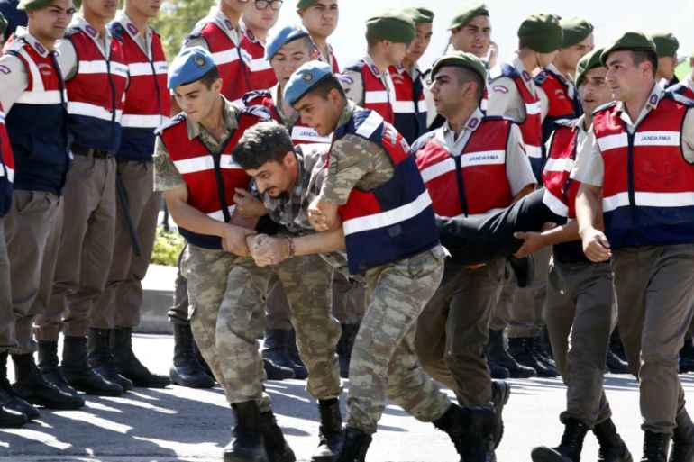 Soldier accused of attempting to assassinate Turkish President Erdogan on the night of the failed coup is carried by gendarmes to the courthouse in Mugla