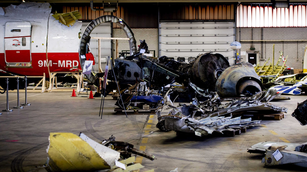 Debris of the MH17 plane crash brought back from the crash site in eastern Ukraine is on display for friends and family of the flight's victims at airbase Gilze-Rijen in Rijen, The Netherlands, March 3, 2015 [Robin van Lonkhuijsen]