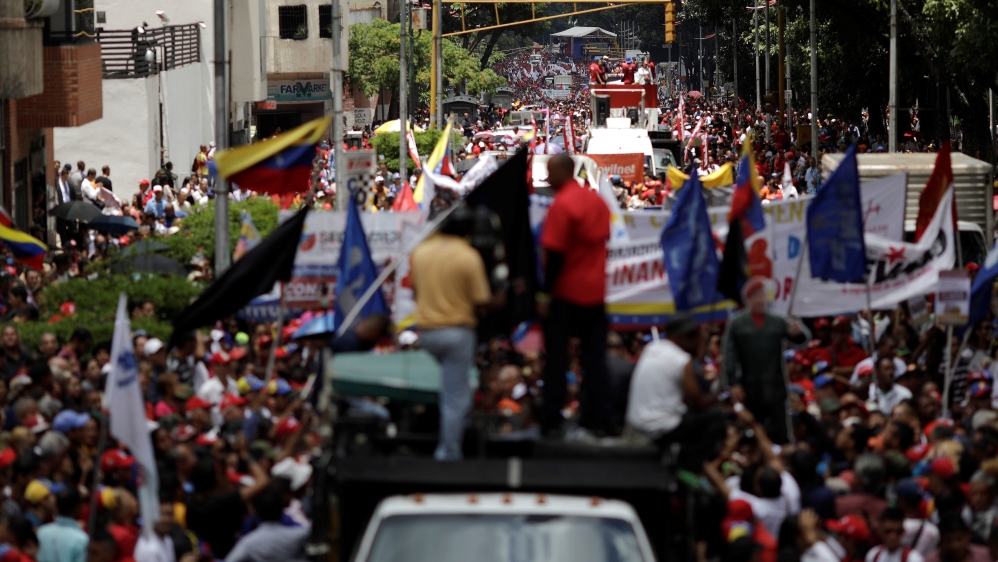 Pro-government supporters march in Caracas [Ueslei Marcelino/Reuters]