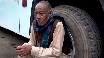 Forty years of painting buses without any safety equipment has taken its toll on Mohammed Rafiq [Hassan Ghani/Al Jazeera]