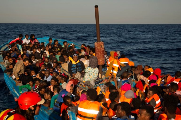 Migrants from Somalia and Eritrea flee Libya, crowded aboard a wooden boat sailing on the Mediterranean Sea