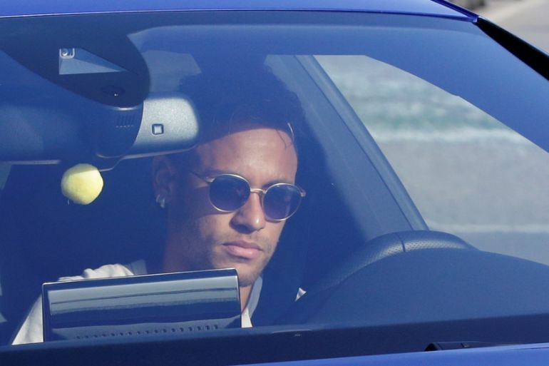 Brazilian soccer player Neymar drives to arrive to Joan Gamper training camp near Barcelona