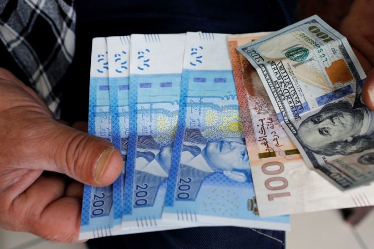 Moroccan dirhams and U.S. Dollar notes are pictured in a photo illustration in Casablanca
