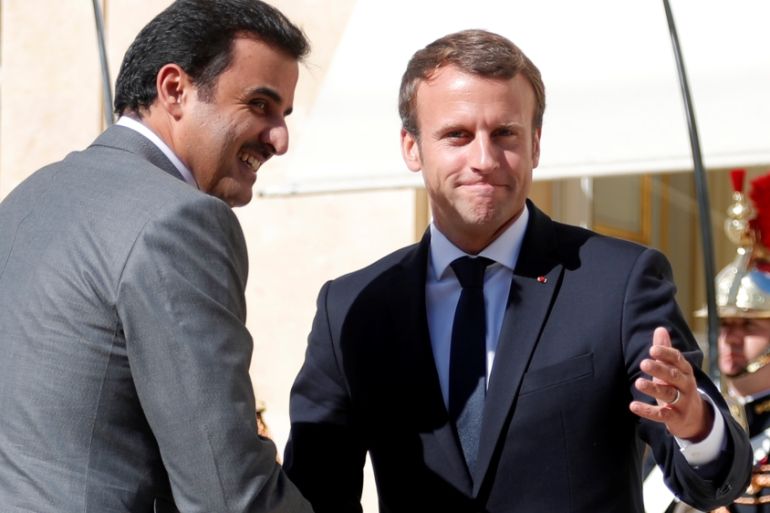 French President Emmanuel Macron greets Qatar Emir Sheikh Tamim bin Hamad al-Thani at the Elysee Place in Paris