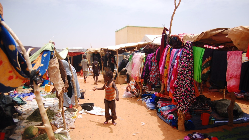 Malian refugees and Mauritanians sell products side-by-side in the camp, which organisers hope will promote peaceful coexistence between them [Jillian Kestler-D'Amours/Al Jazeera] 