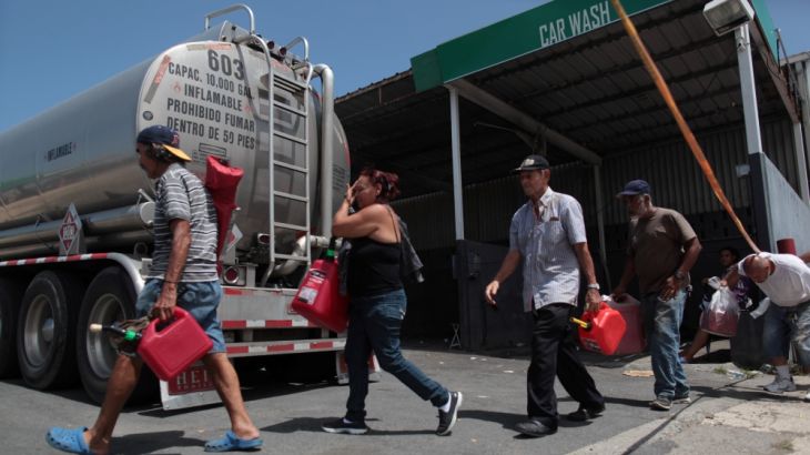 People enter a gas station to fill up their fuel containers, after the island was hit by Hurricane Maria, in San Juan