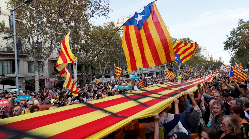 People wave Catalan flags during recent a demonstration organised by Catalan pro-independence movements [File: Rafael Marchante/Reuters]