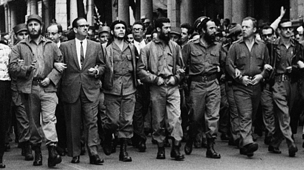 Cuban leaders walk arm-in-arm at the head of the March 5, 1960 funeral procession for the victims of the La Coubre explosion, blamed by the Cuban government on a US bomb attack on the Cuban ship La Coubre in the harbor of Havana [The Associated Press]