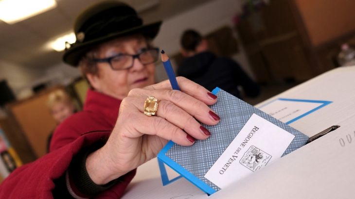 A woman casts her vote for Veneto''s autonomy referendum at a polling station in Venice