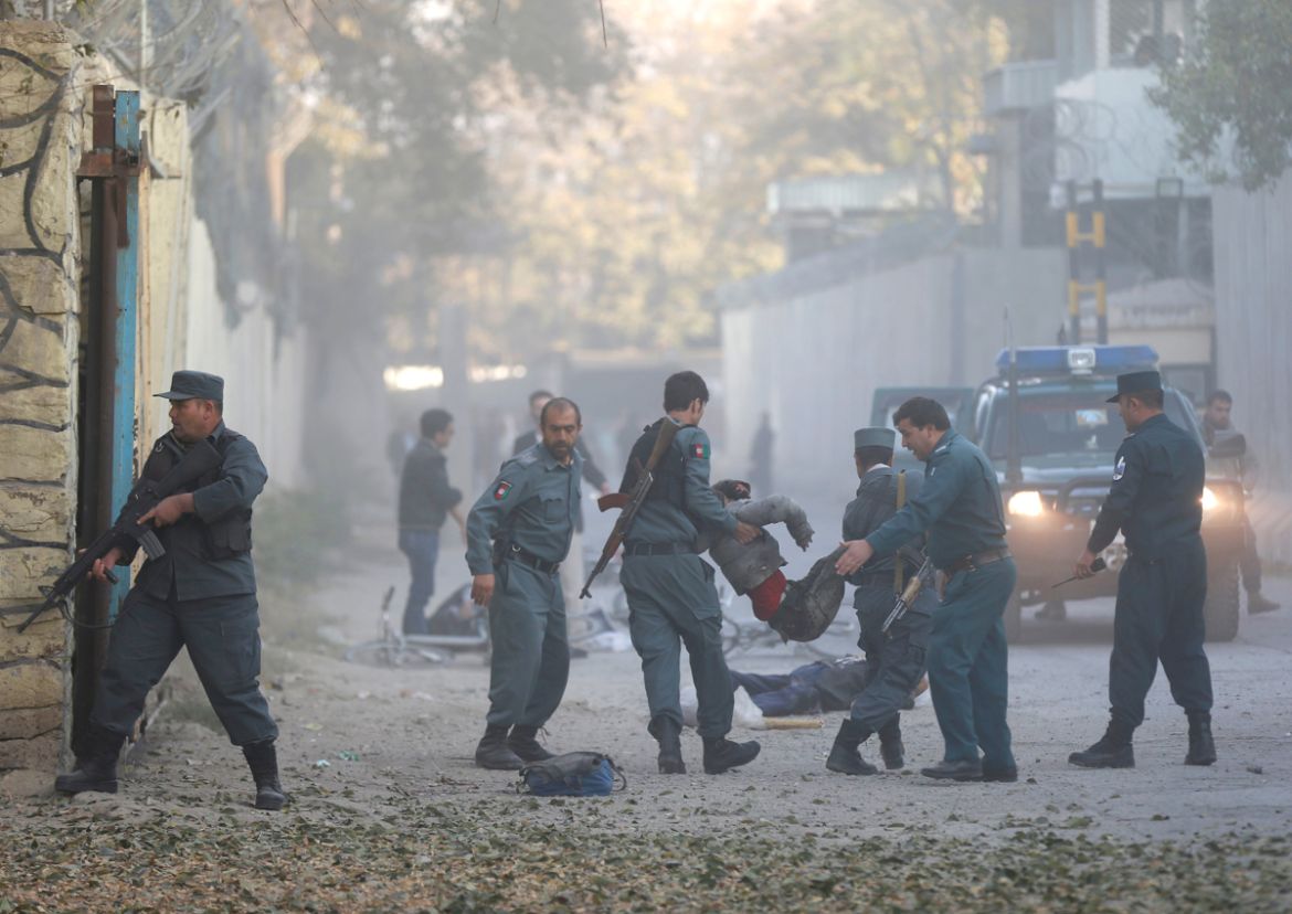 ATTENTION EDITORS - VISUAL COVERAGE OF SCENES OF INJURY OR DEATH Afghan policemen carry an injuried after a blast in Kabul, Afghanistan October 31, 2017. REUTERS/Mohammad Ismail TEMPLATE OUT