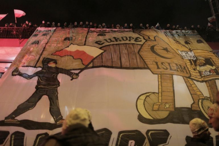 Protesters hold anti refugee banner during a rally, organised by far-right, nationalist groups, to mark 99th anniversary of Polish independence in Warsaw
