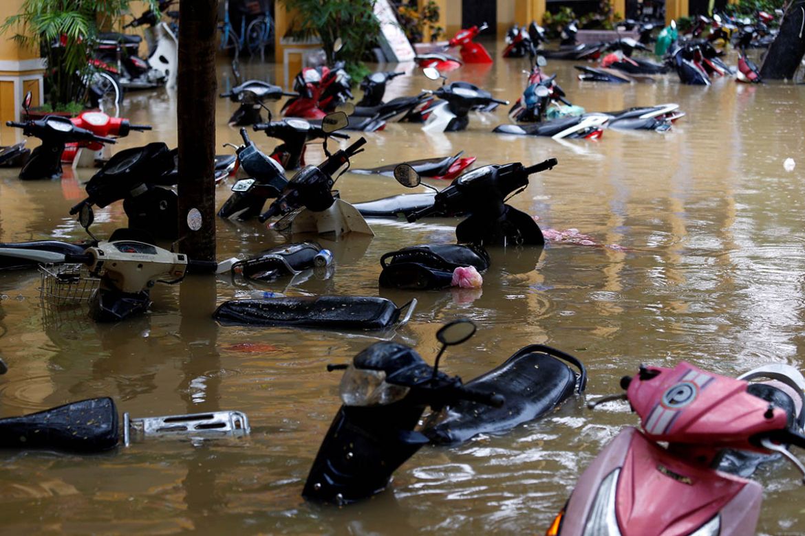 Motorbikes are seen along a flooded street in Hoi An. REUTERS/Kham