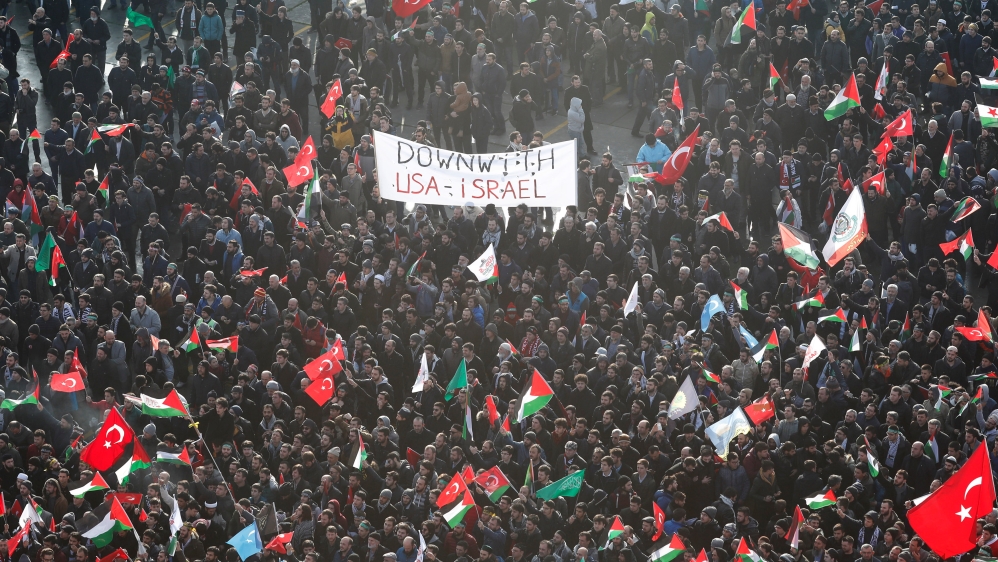 Demonstrators wave Turkish and Palestinian flags at a rally in Istanbul [Osman Orsal/Reuters]