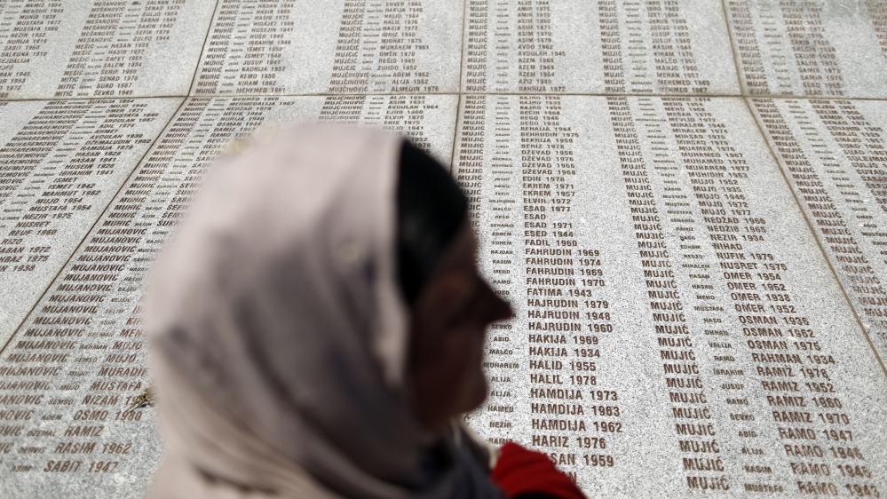A woman stands in front of the Memorial Center during a reburial ceremony of 136 newly identified victims in Potocari, near Srebrenica. There is no suggestion that the woman pictured in this image is sexual assault victim [File: Antonio Bronic/Reuters]
