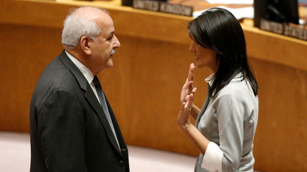United States ambassador to the UN Nikki Haley spoke with Palestinian ambassador to the UN Riyad Mansour before the start of a UN Security Council meeting [Brendan McDermid/Reuters]