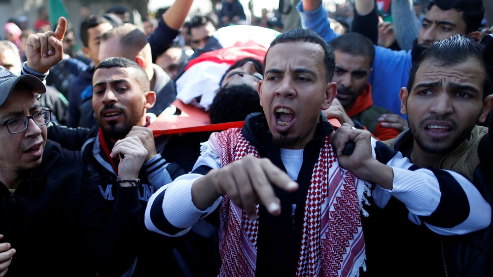 Mourners carry Abu Thurayyah's body during his funeral in Gaza City on Saturday [Suhaib Salem/Reuters]