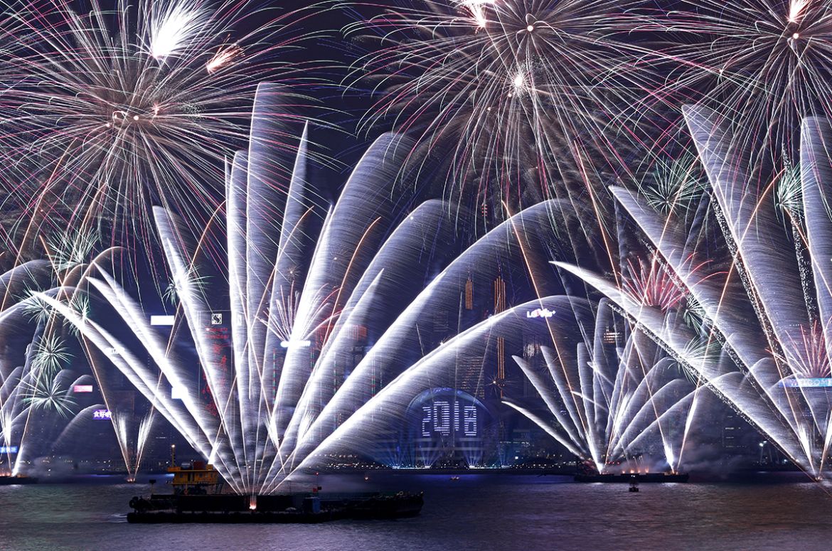 Fireworks explode over Victoria Harbour and Hong Kong Convention and Exhibition Centre during a pyrotechnic show to celebrate the New Year in Hong Kong, China January 1, 2018. REUTERS/Tyrone Siu TPX I
