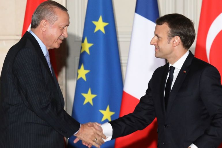 French President Emmanuel Macron and Turkish President Recep Tayyip Erdogan shake hands after a joint press conference at the Elysee Palace in Paris