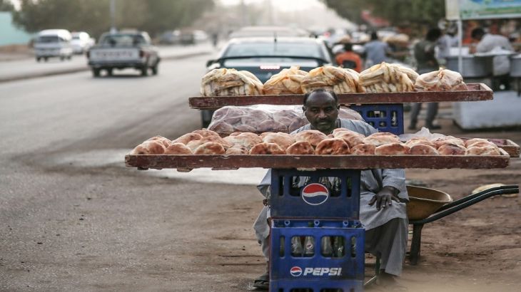 A bread seller waits for customers in Omdurman, Sudan.