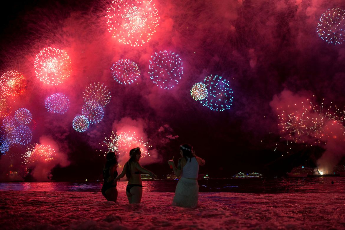 People watch as fireworks explode over Copacabana beach during New Year celebrations in Rio de Janeiro, Brazil January 1, 2018. REUTERS/Lucas Landau TPX IMAGES OF THE DAY