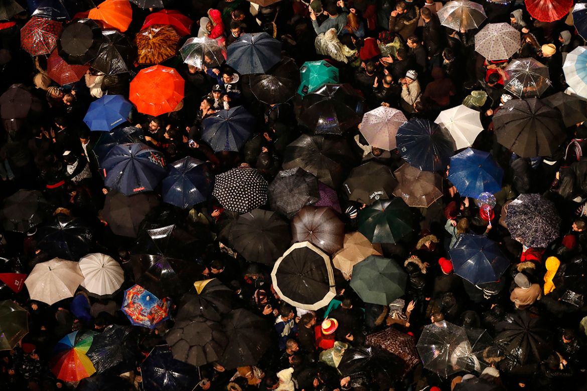 Revelers hold their umbrellas during New Year''s celebrations at the Parliament square, in downtown Beirut, Lebanon, Monday, Jan. 1, 2018. (AP Photo/Hussein Malla)