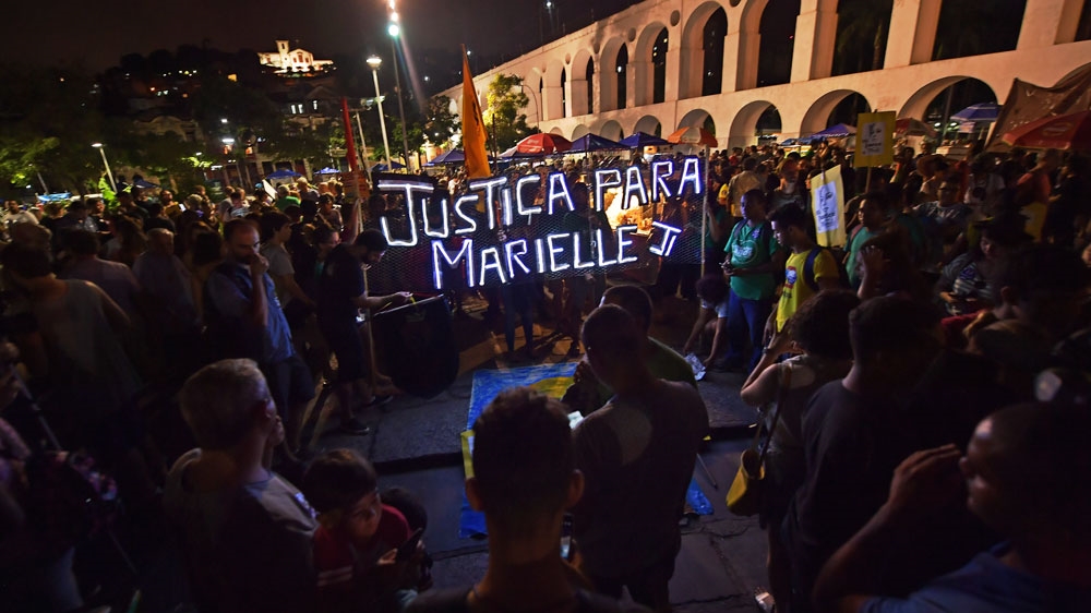 People gather in Lapa neighbourhood, Rio de Janeiro, Brazil during a demonstration calling for justice over the murder of Marielle Franco [File: Carl de Souza/AFP] 