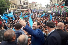 Lebanon's Prime Minister Saad Hariri takes selfies during an election campaign in Tripoli, Lebanon April 27, 2018 [Dalati Nohra/Reuters]