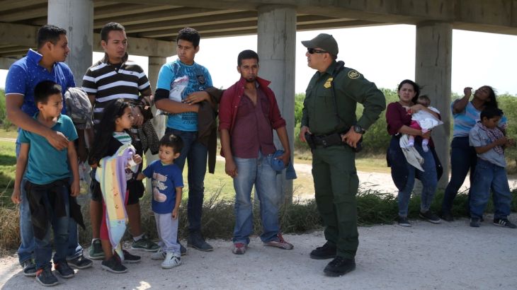Border patrol agent Ramirez talks with immigrants