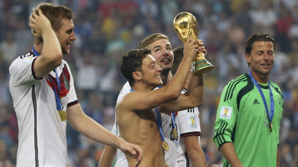 




Ozil holds the World Cup trophy after Germany beat Argentina at the 2014 final in Brazil [Antonio Lacerda/EPA]





Ozil holds the World Cup trophy after Germany beat Argentina at the 2014 final in Brazil [Antonio Lacerda/EPA]

