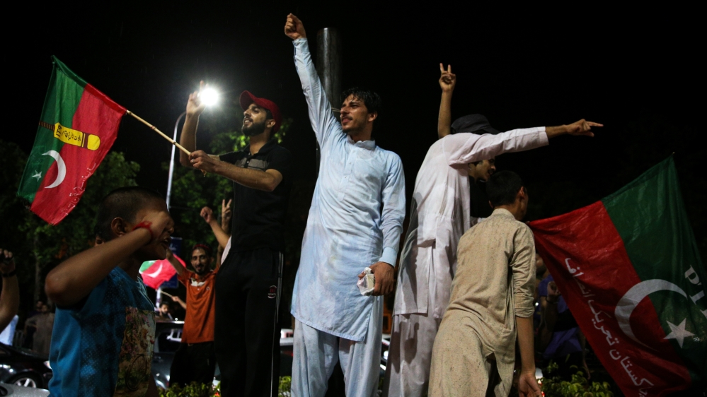 Imran Khan supporters wave PTI flags in the capital [Athit Perawongmetha/Reuters]