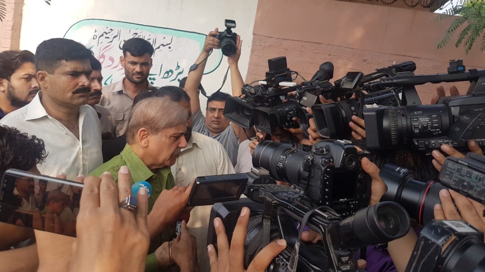 PML-N leader Shehbaz Sharif in line at his local polling station in the NA130 constituency of Lahore [Asad Hashim/Al Jazeera] 