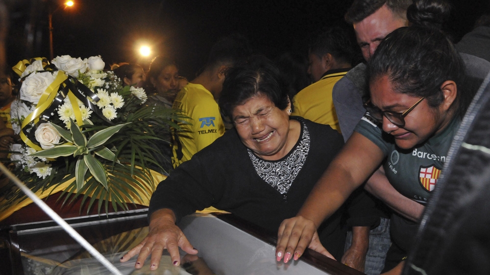 Relatives mourn over the coffin of a football fan killed in a bus crash at the Isidro Romero soccer stadium in Guayaquil on Sunday[Jose Sanchez/AP Photo] 