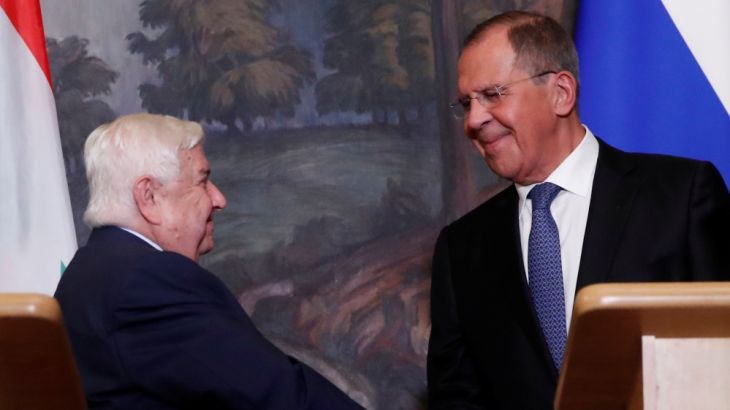Russian Foreign Minister Lavrov shakes hands with Syrian Foreign Minister al-Moualem during a joint news conference following their talks in Moscow