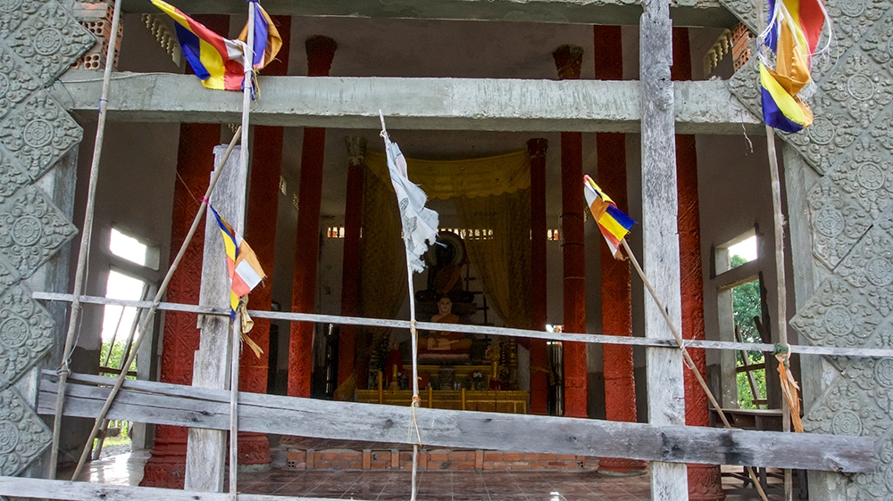 A pagoda founded by Prak Thon, a resident who has passed away, is boarded up and empty [Andrew Nachemson/Al Jazeera]