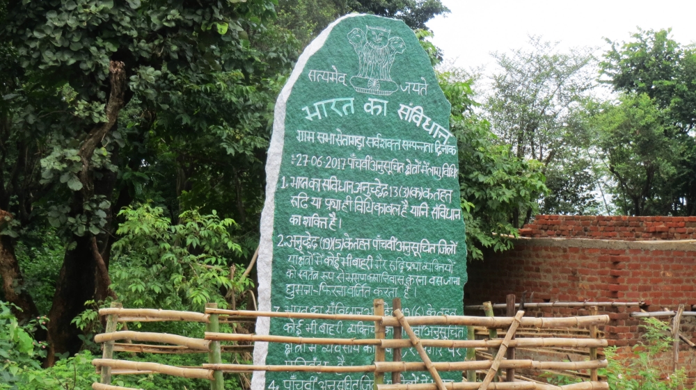 Large stone edicts freshly painted green and white can be seen in many of Khunti’s hamelts [Anumeha Yadav/ Al Jazeera]
