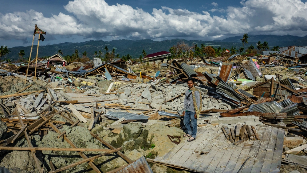 Muhammad Rizal standing on what used to be his home in Petobo, a month after the Sulawesi earthquake and tsunami [Ian Morse/Al Jazeera]