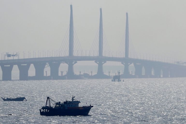 A boat sails near the Hong Kong-Zhuhai-Macau Bridge, in Zhuhai city, south China''s Guangdong province, Wednesday, March 28, 2018. The Hong Kong-Zhuhai-Macau Bridge, the world''s longest cross-sea proje