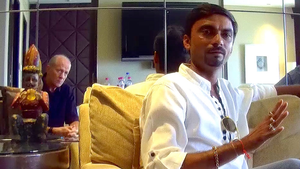 Munawar, right, speaking to Al Jazeera's David Harrison at the Taj Hotel, Mumbai, India [Al Jazeera] 