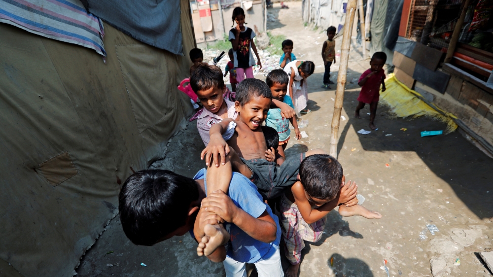 Children from the Rohingya community play outside their shacks in a camp in New Delhi, India October 4, 2018 [Adnan Abidi/Reuters]