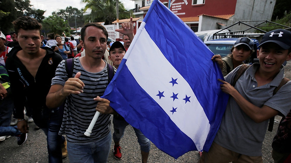 Hondurans react after crossing the border between Honduras and Guatemala, in Agua Caliente, Guatemala [Jorge Cabrera/Reuters]