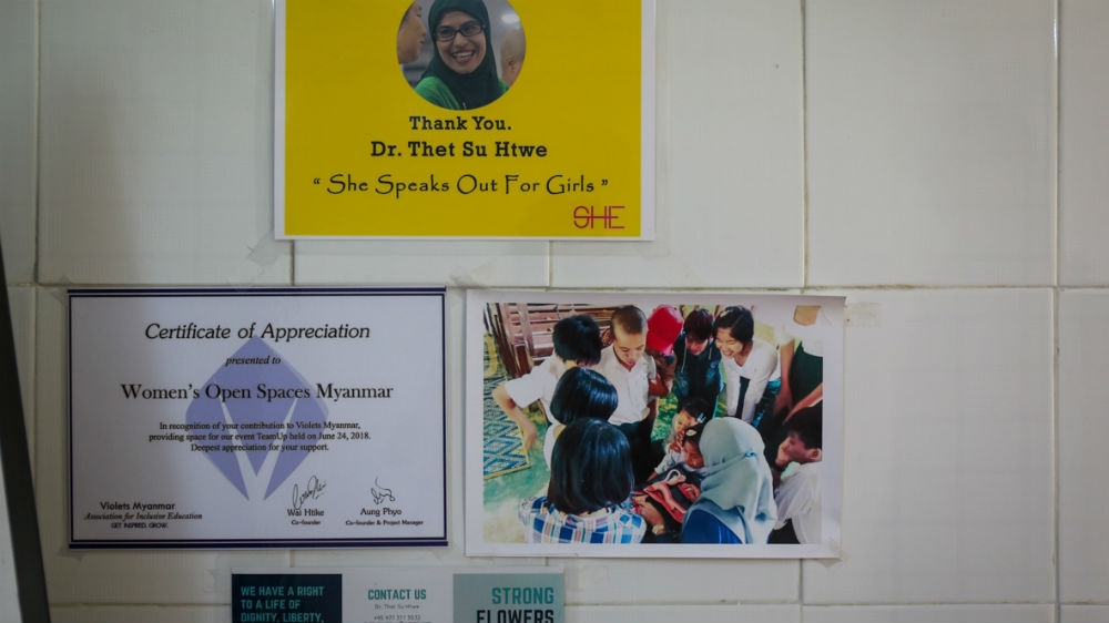 Strong Flowers material on the wall at the Women Open Spaces office in Yangon where Dr Thet Htwe runs her classes [Victoria Milko/Al Jazeera]
