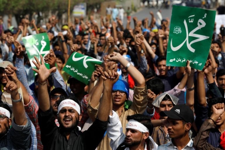 Supporters of Jamiat Talba Islam hold placards as they chant slogans during a protest in Karachi