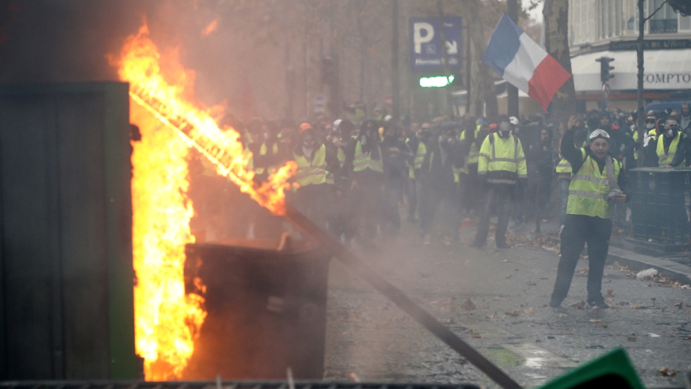Some protesters set fire to barricades and hurled projectiles at riot police [Stephane Mahe/ Reuters]