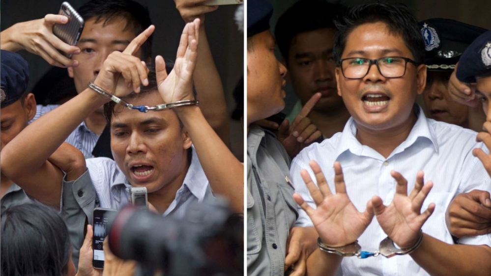 Kyaw Soe Oo (L) and Wa Lone (R) escorted by police out of the Yangon court in September [Thein Zaw/Associated Press]