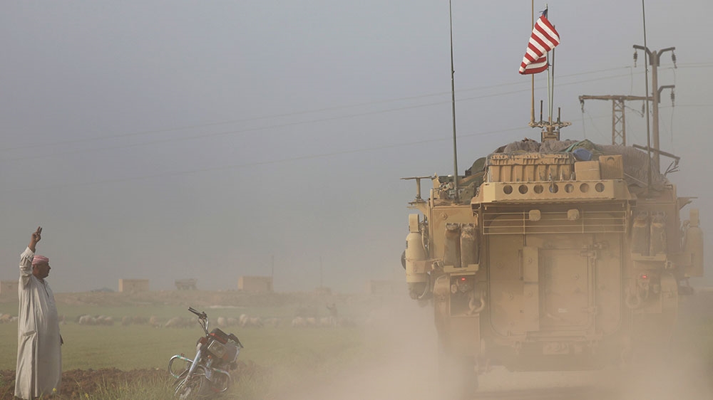 A US military vehicles drives in the Syrian town of Darbasiya next to the Turkish border [File: Rodi Said/Reuters]