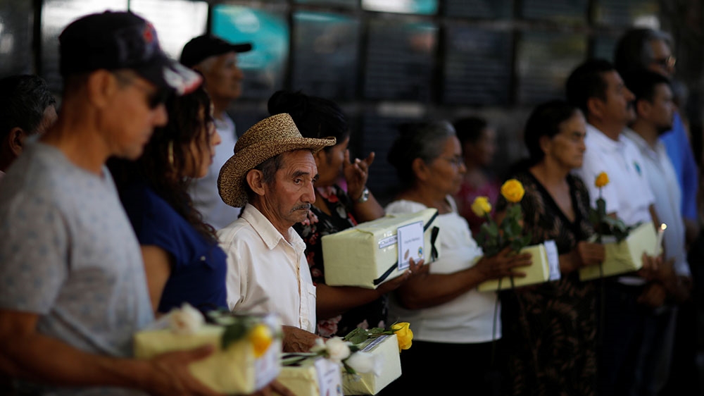 Relatives participate in a ceremony to commemorate the 37th anniversary of El Mozote massacre in Meanguera, El Salvador [Jose Cabezas/Reuters] 