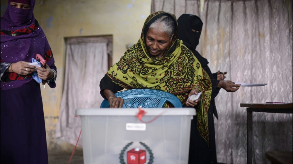 
A woman casts her vote during the general election in Dhaka, Bangladesh [Mahmud Hossain Opu/Al Jazeera]

