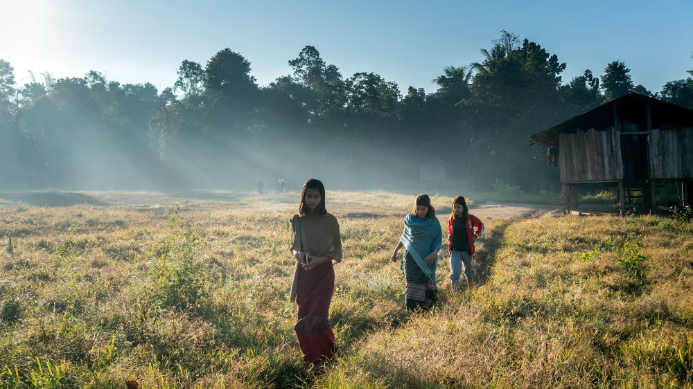 Karen women walk through a village in the Salween Peace Park, Mutraw District [Matias Bercovich/Al Jazeera]